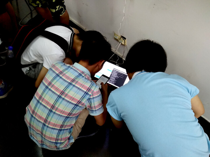 Lion Yang and couple others working hard for Internet connection in the venue.